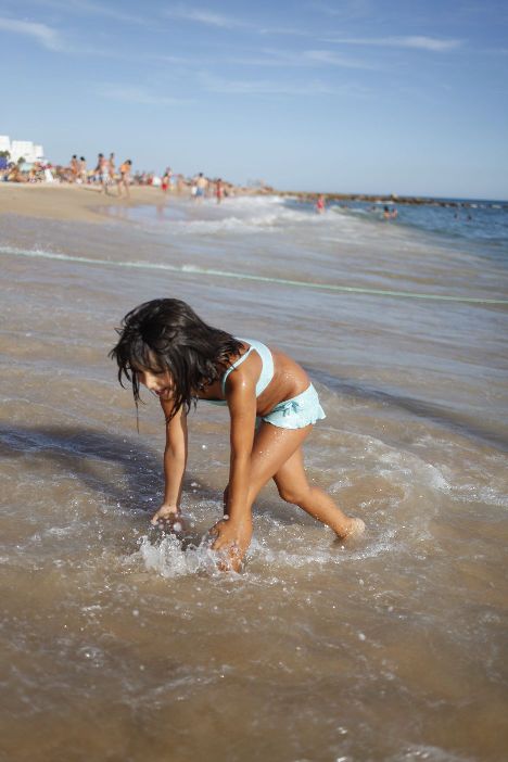 Little Girl Playing On The Beach In Quarteira